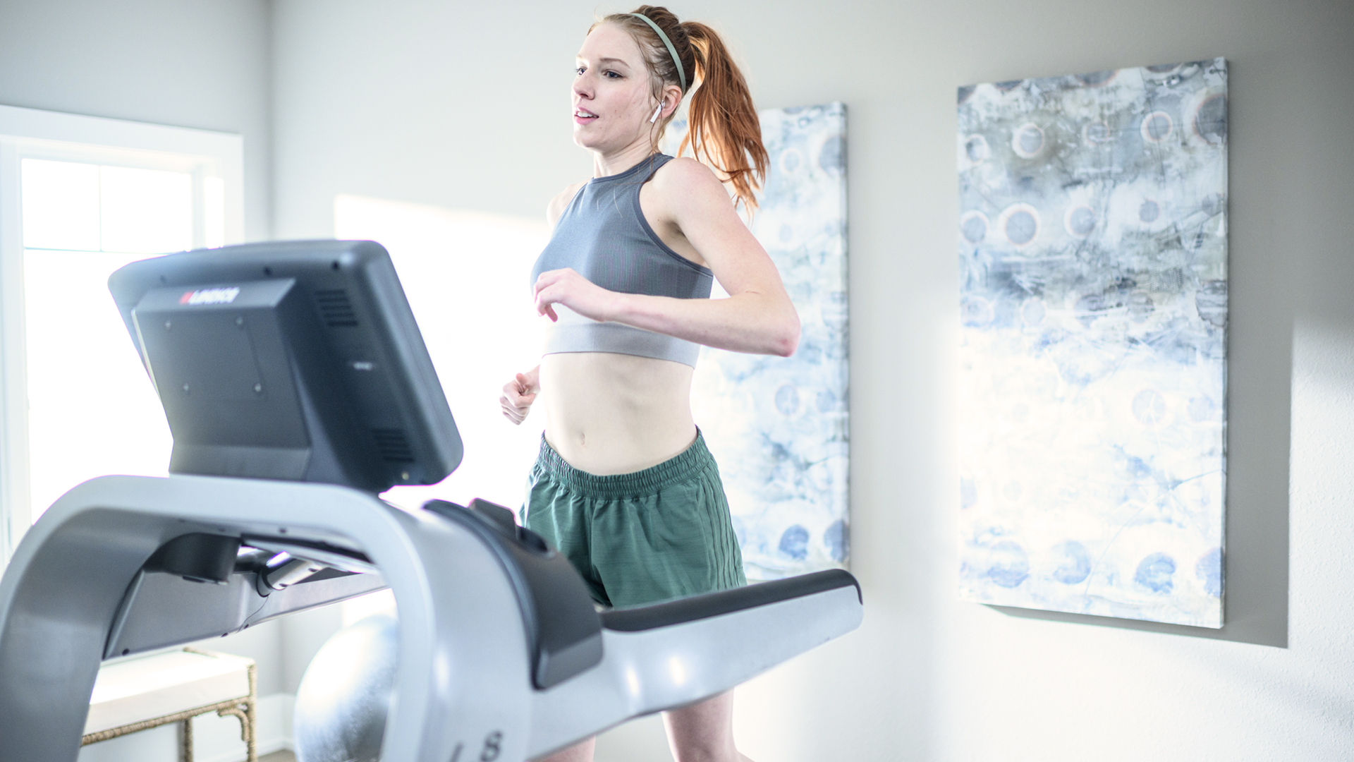 Woman running with Landice achieve console