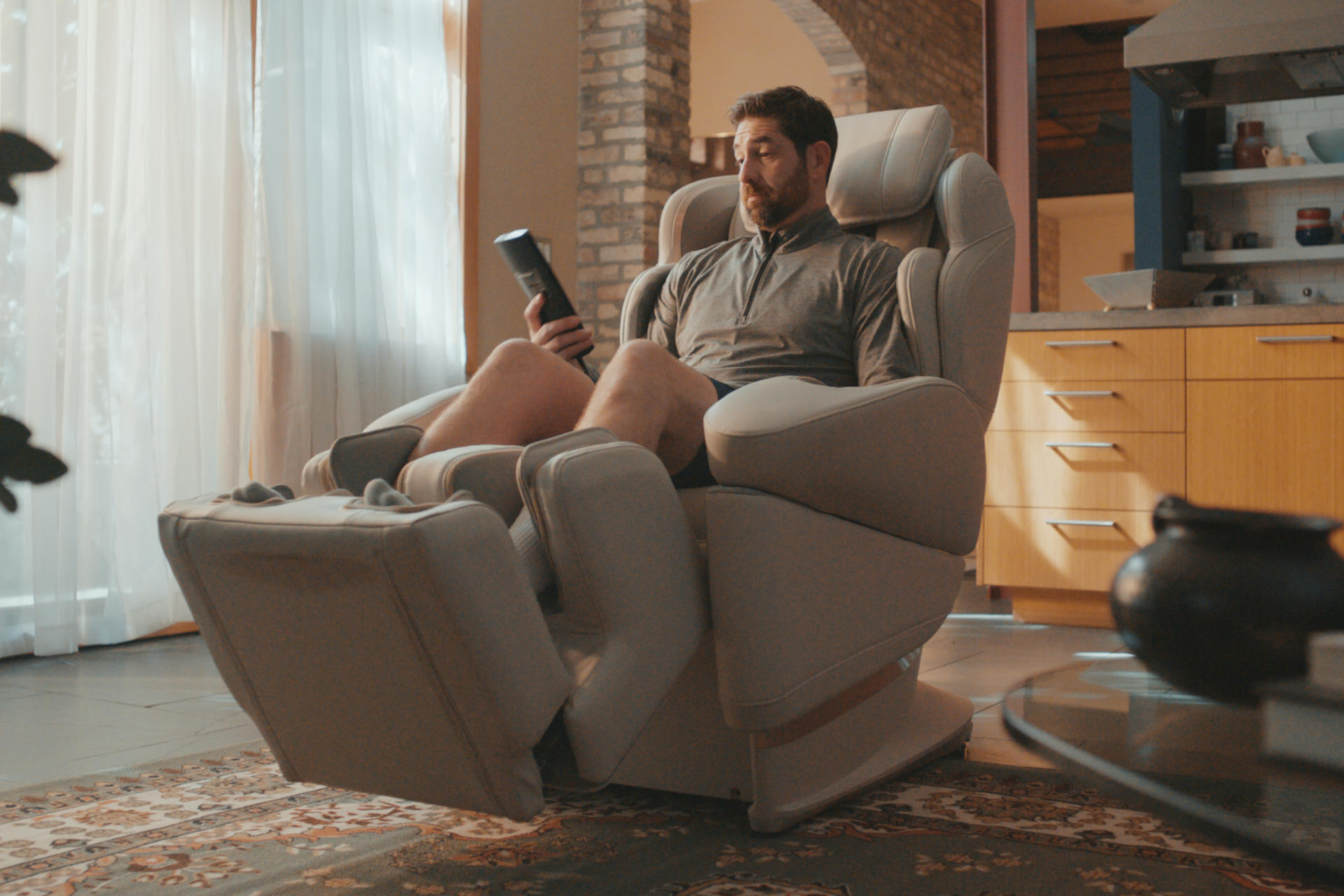 Man relaxing in a massage chair in his living room