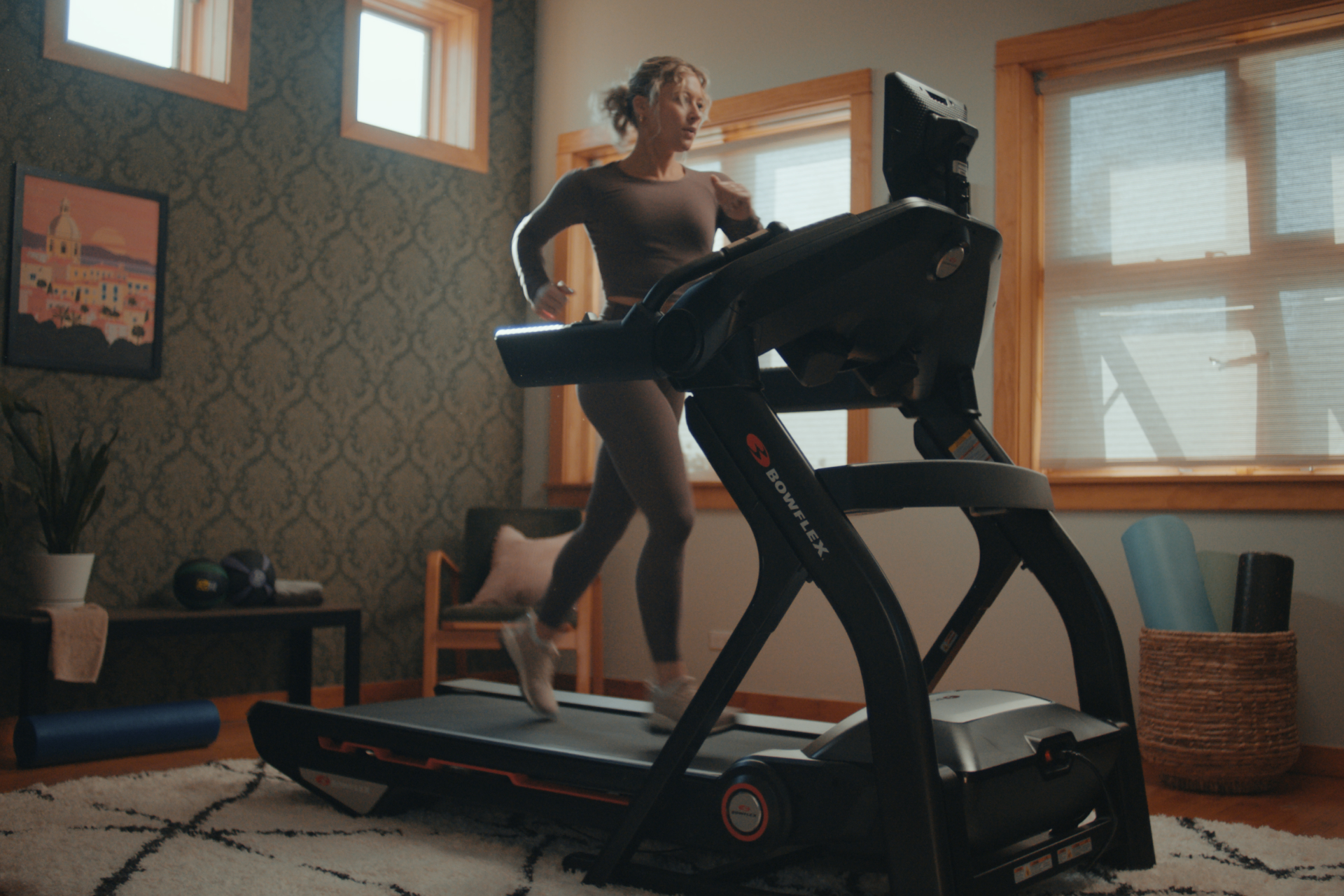 Woman running on a Bowflex Treadmill 10