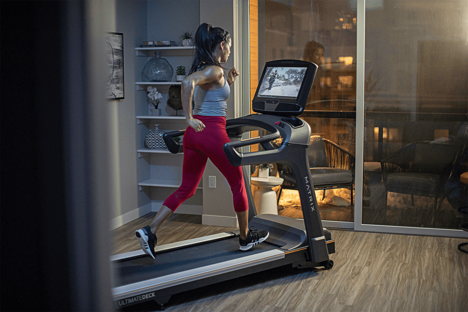 Woman running on Matrix treadmill in home
