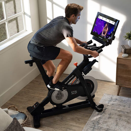 Woman working out on NordicTrack indoor cycle