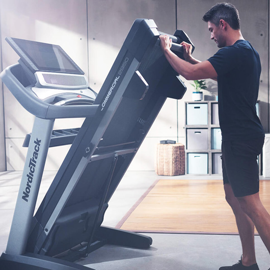 Man folding NordicTrack treadmill