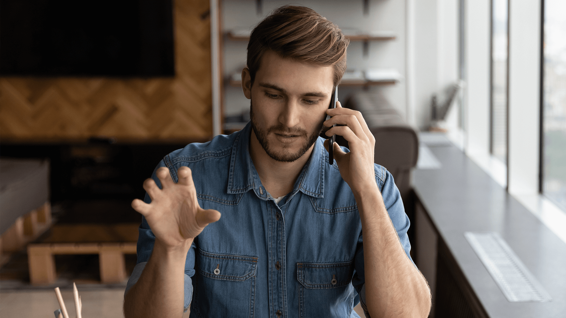 Man talking on the phone at desk