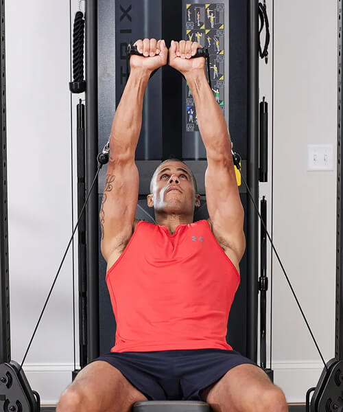Man working out on a functional trainer home gym
