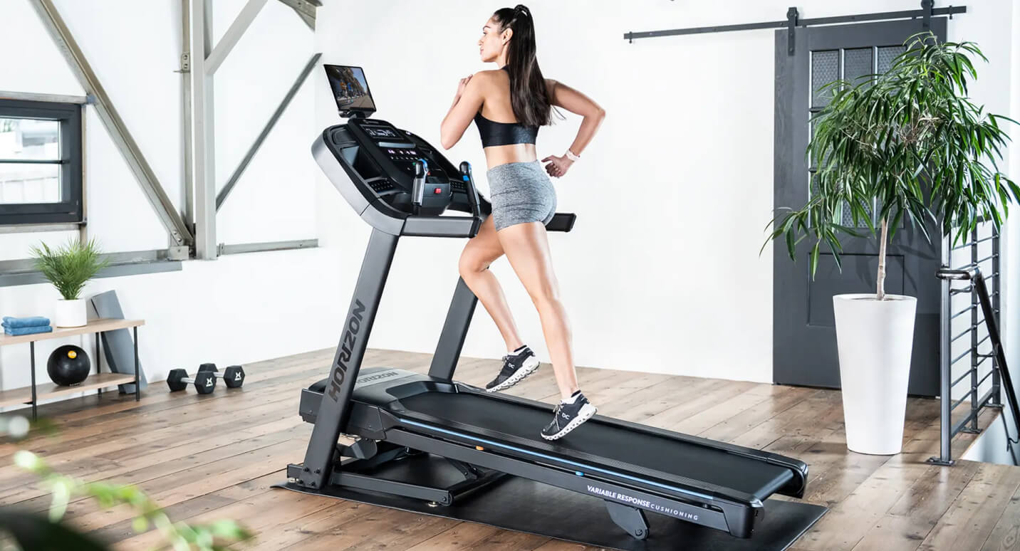 Woman working out on a Horizon treadmill in her family room