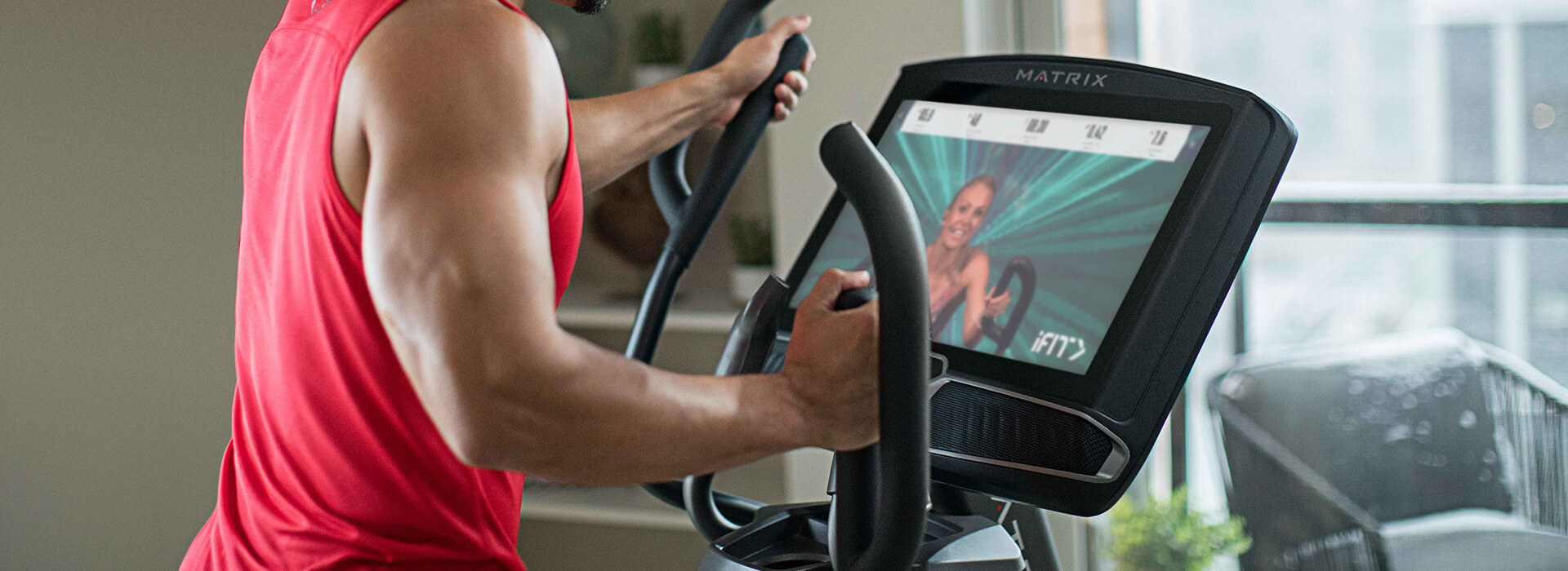 Woman standing on Matrix treadmill interacting with console