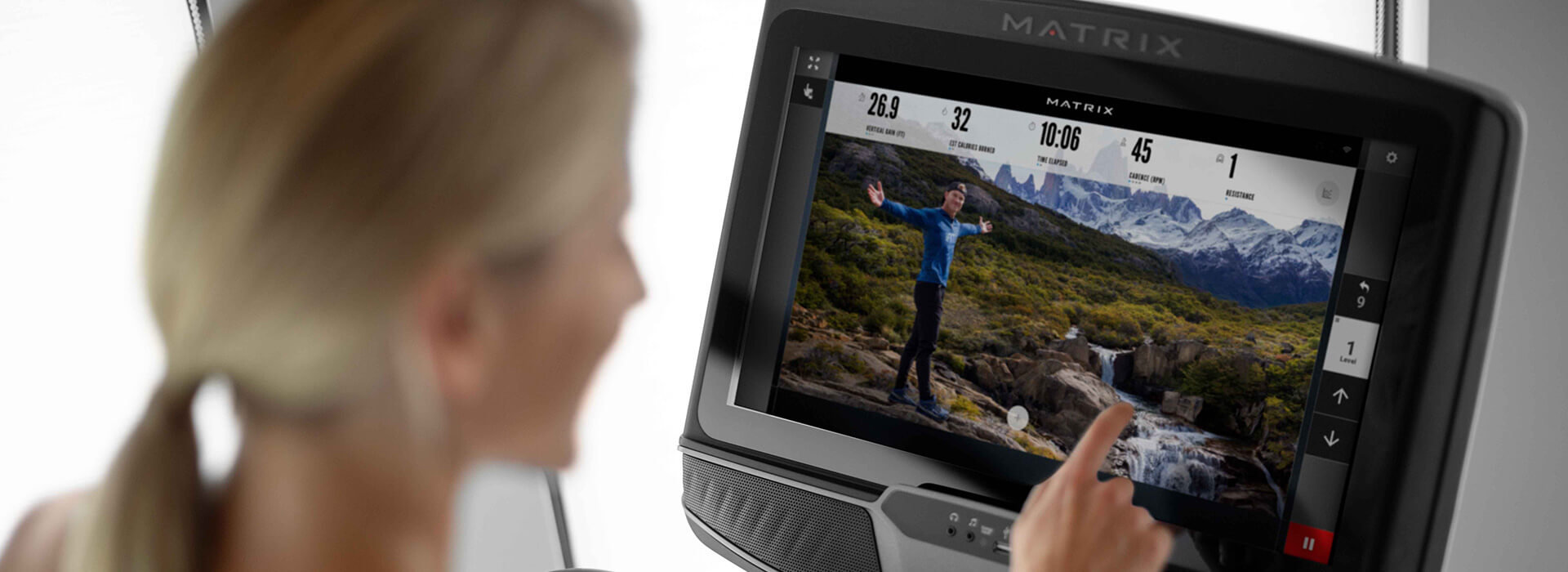 Woman interacting with iFIT app on Matrix XUR console