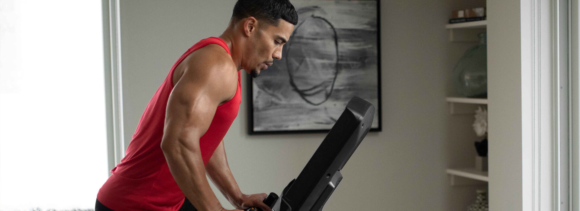 Woman interacting with iFIT app on Matrix console